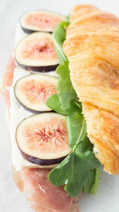 a sandwich with figs and greens on it