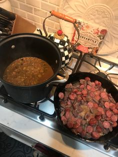 two pans filled with food sitting on top of a stovetop next to each other