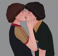 two people are kissing each other with their hands on their cheeks and one is holding his face