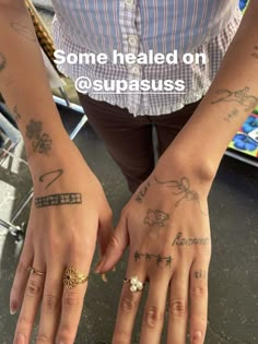 two hands with different tattoos on them