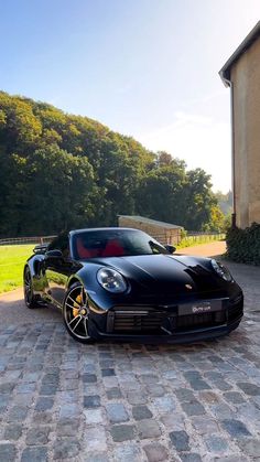 a black sports car parked in front of a house