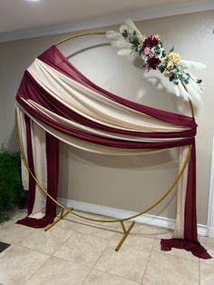 a bed with red and white drapes on top of it