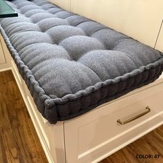 a gray mattress sitting on top of a white dresser