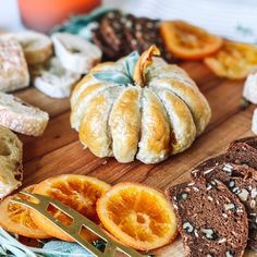 an assortment of breads and pastries on a cutting board