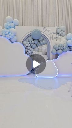 a white table topped with blue and white balloons