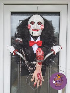 a creepy doll is hanging on the front door