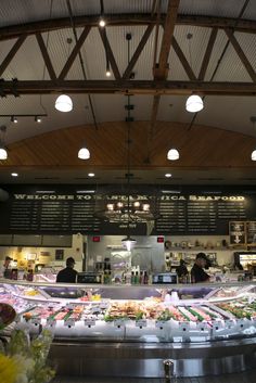 the inside of a deli filled with lots of food