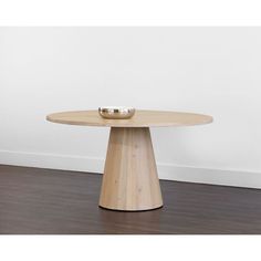 a wooden table with two bowls on it and a white wall in the back ground