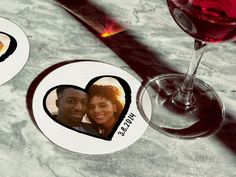 two personalized coasters with an image of a man and woman in the heart