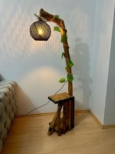 a lamp that is sitting on top of a wooden table next to a tree stump