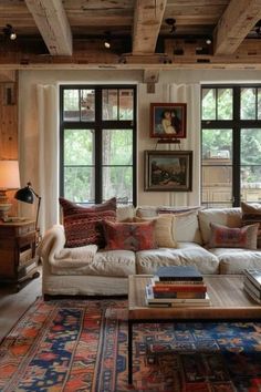 a living room filled with furniture and lots of windows