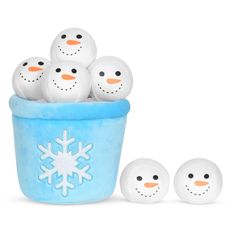 a group of snowmen sitting in a blue bucket next to three smaller white balls