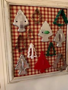 a shadow box with christmas cookie cutters in it