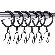 several black hooks hanging from a metal bar