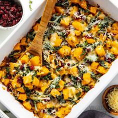 a casserole dish with butternut squash and spinach