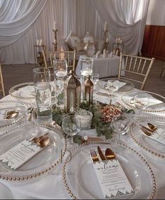 the table is set with place settings and silverware for an elegant dinner party or wedding reception