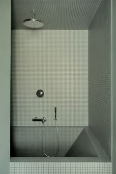 a bathtub with a shower head and faucet