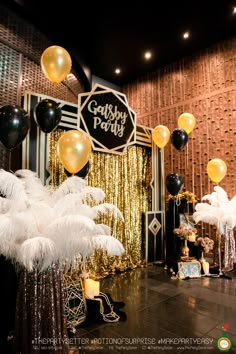 an image of a party setting with balloons and feathers on the floor in front of it