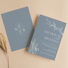 two wedding cards on top of each other next to a leafy plant with the letter b