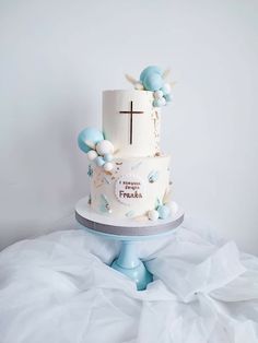 a three tiered cake with blue and white decorations