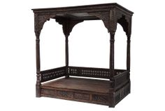 an old wooden bed with carved wood posts and drawers on the bottom shelf, isolated against a white background