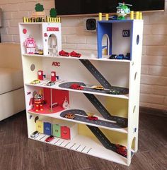 a toy house with cars and trucks on the shelves