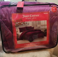 a purple suitcase with an advertisement for the luxury bedding company on it's front