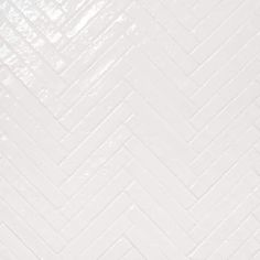 a white tile wall with an interesting pattern on it's side and the floor