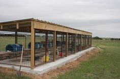 a fenced off area with several cages in it