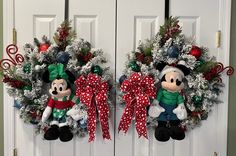 two christmas wreaths with mickey and minnie mouse decorations hanging on the front door doors