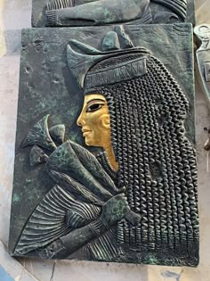 an ancient egyptian sculpture is displayed on the ground