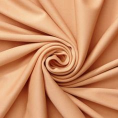 an image of a close up view of a plain tan colored fabric with very thin folds