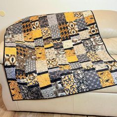 a couch with a patchwork quilt on it