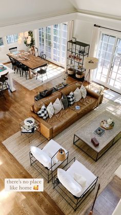 an overhead view of a living room with couches, tables and chairs in it