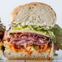 a large sandwich with meat, lettuce and cheese