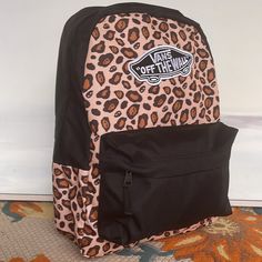 Vans Realm Backpack Nwt Authentic Leopard Print The Realm Backpack Is A Two-Pocket Backpack Featuring A Zippered Main Compartment With An Interior Laptop Sleeve And Front Organization Pocket. There Are Adjustable Padded Straps, Debossed Lining At The Interior Back Panel, And A Finished With A Vans Off-The-Wall Patch. Our Team Has Set Ambitious Sustainability Goals. Big Or Small, All Of Our Efforts Add Up To Positive Change. To Earn The Vr3 Checkerboard Globe Logo, At Least 30% Of The Product Mus Carhartt Double Knee Pants, Vans Bags, Globe Logo, Adidas Track Suit, Vans Black And White, Pleated Trousers, Vans Off The Wall, Vans Black, Women's Vans