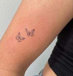 two butterflies tattoo on the arm