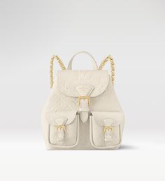 M47106  The playful Backup backpack is made from Monogram Empreinte leather, with the Monogram pattern subtly embossed into the cowhide. This versatile bag can be carried on the back or shoulder, thanks to its removable and adjustable strap, by hand, with its sturdy top handle, or even cross-body using the braided chain. Beige Lv Bag, Louis Vuitton Beige, Luxury Cream-colored Standard Backpack, Cream Louis Vuitton Bag, Beige Skin, Farfetch Louis Vuitton Bag, Trunk Bag, Monogram Bag, Wallet Pouch