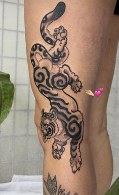 a woman's leg with a tiger tattoo on it