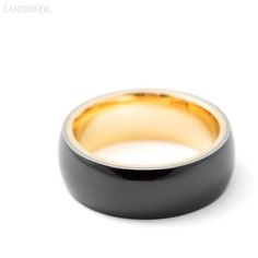 a black and gold wedding ring on a white background