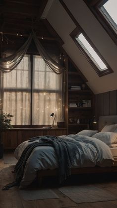 an attic bedroom with slanted ceilings and large windows is lit up by string lights