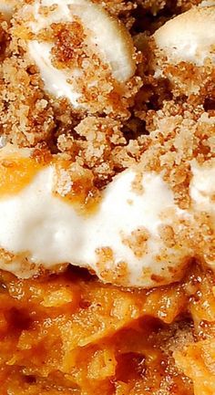 a close up view of some food with crumbs and cream on it's surface