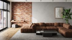 a modern living room with brick walls and flooring, large sectional sofa in front of the window