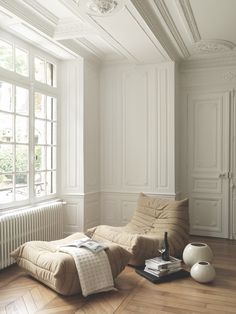 a living room with white walls and wooden floors