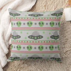 a pillow that has aliens on it