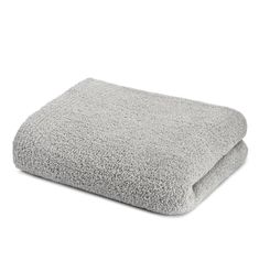 a gray blanket folded on top of a white surface