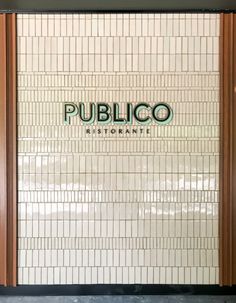 the entrance to publico kitchenette with tiled walls and doors that lead into it