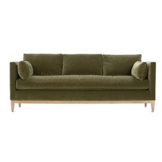 a green couch with two pillows on the back and one arm folded up in front