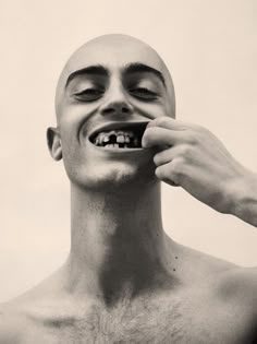 a man is brushing his teeth with an electric toothbrush in black and white photo