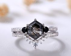 an engagement ring with black and white diamonds